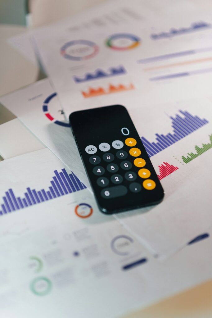 smartphone calculator app on financial report papers