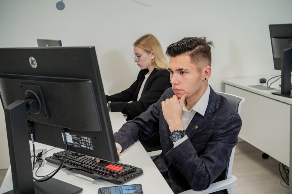 a man sitting at a desk in front of a computer