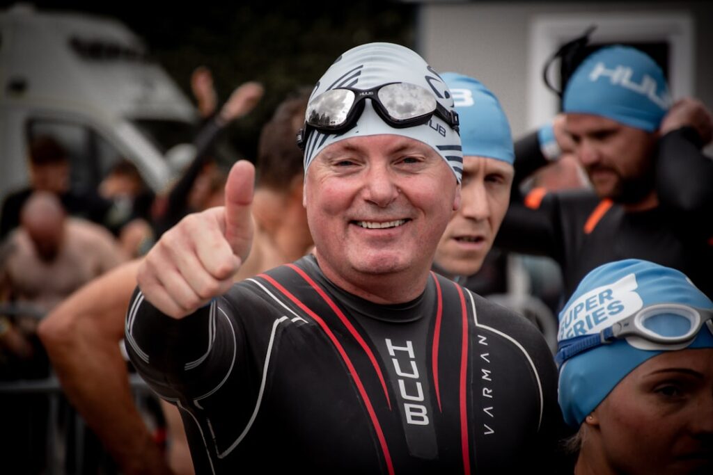 Man in wetsuit gives thumbs up