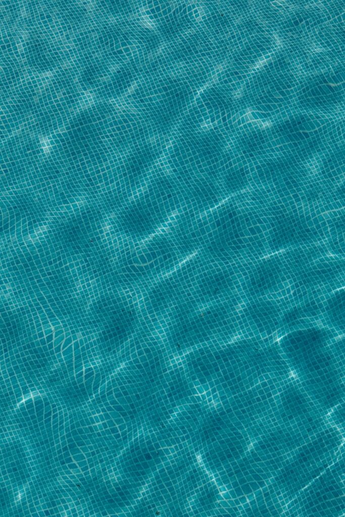 Rippling blue water surface with tiled pattern below