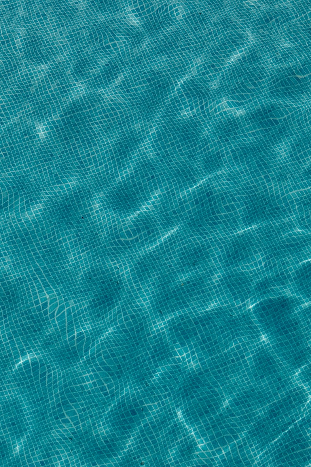 Rippling blue water surface with tiled pattern below